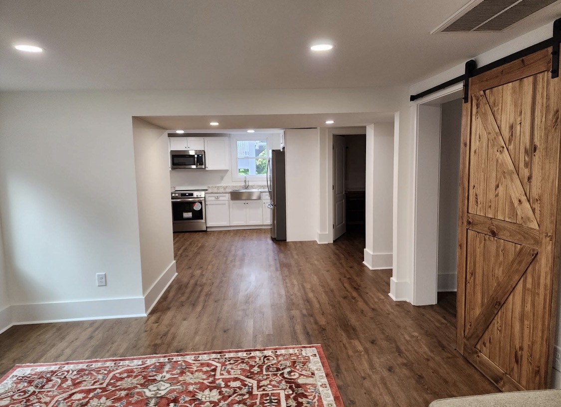 Finished basement with kitchen and barn door